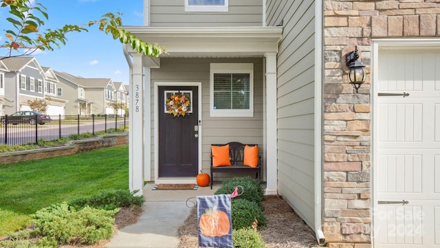 entrance to property with a lawn