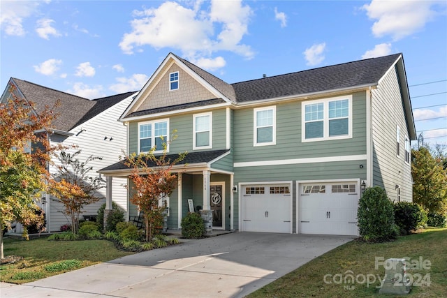 craftsman house featuring a front yard and a garage