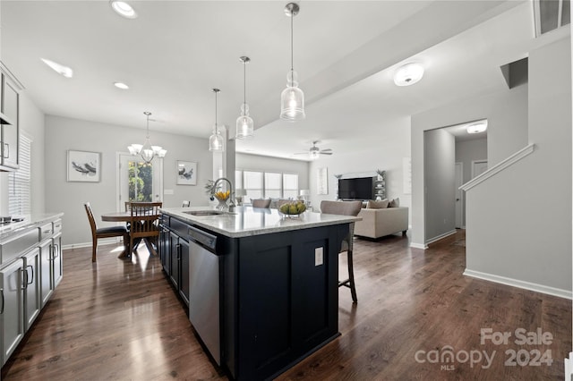 kitchen featuring dishwasher, dark hardwood / wood-style floors, an island with sink, hanging light fixtures, and sink