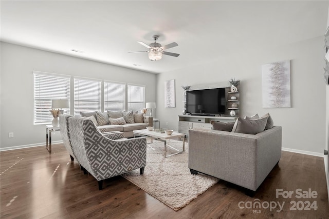 living room featuring ceiling fan and dark hardwood / wood-style flooring