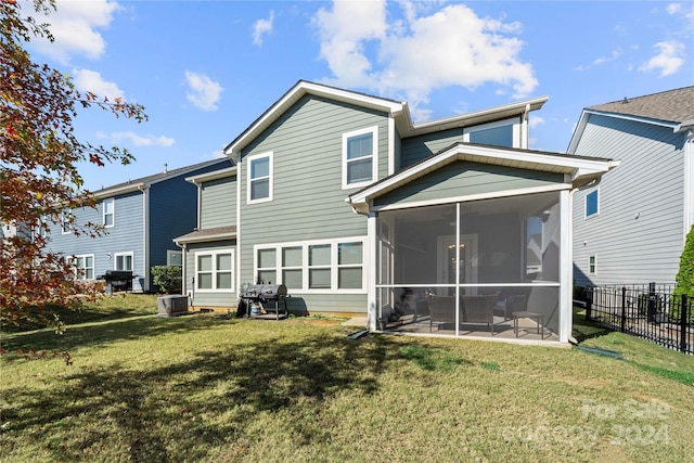 back of property with cooling unit, a lawn, and a sunroom