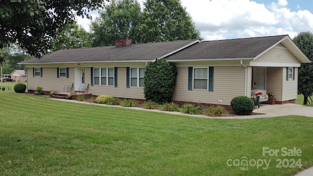 ranch-style home featuring a front yard