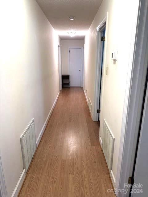 hallway with light hardwood / wood-style flooring