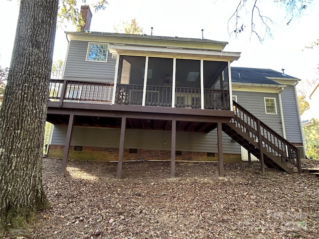 back of house with a sunroom and a wooden deck