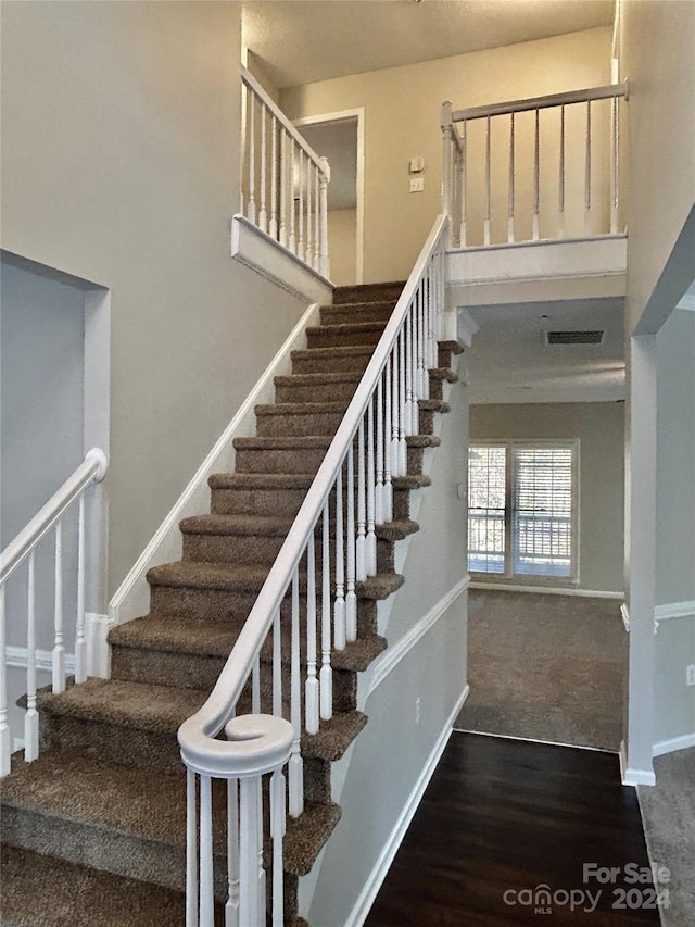 stairs featuring wood-type flooring