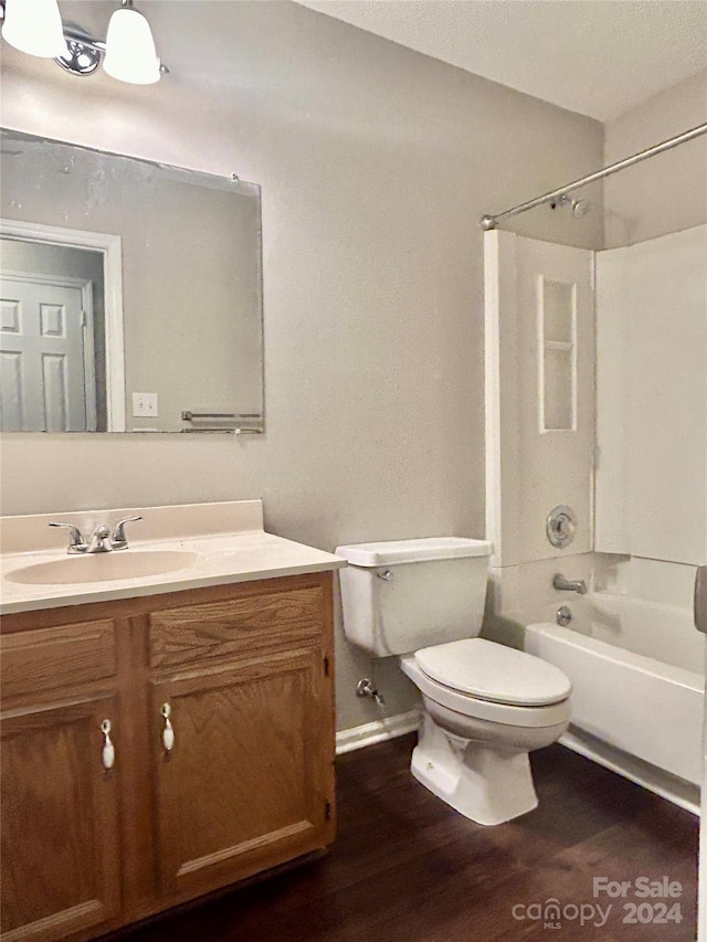 full bathroom with vanity, shower / bathing tub combination, wood-type flooring, and toilet