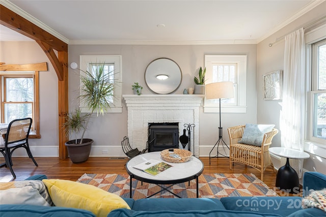 living room featuring hardwood / wood-style flooring, plenty of natural light, and ornamental molding