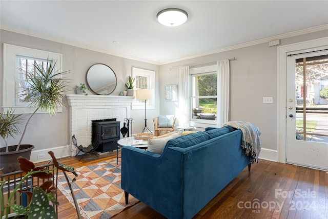 living room with dark hardwood / wood-style floors, a healthy amount of sunlight, and crown molding