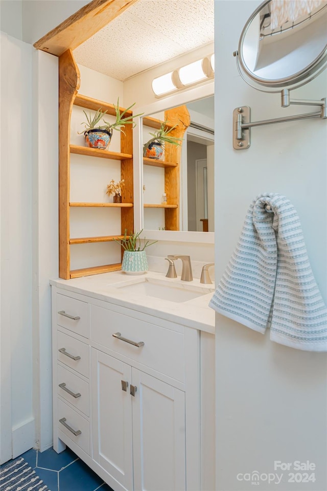 bathroom with tile patterned flooring and vanity