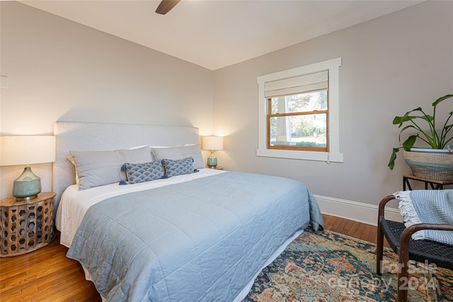 bedroom with ceiling fan and wood-type flooring