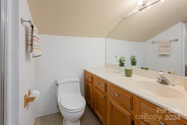 bathroom with vanity, a textured ceiling, and toilet