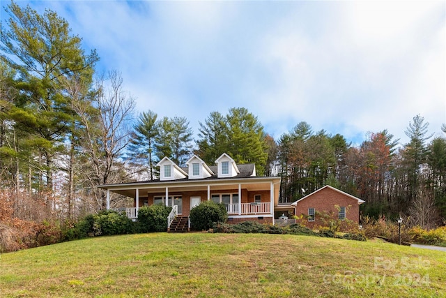 view of front of property with covered porch and a front lawn