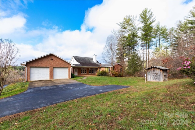 single story home featuring a shed, a front lawn, and a garage