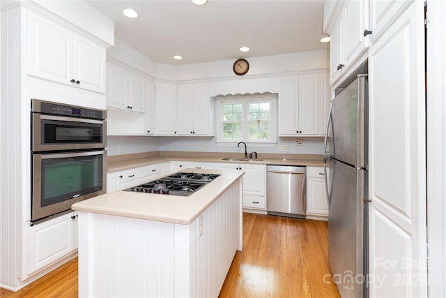 kitchen with white cabinetry, sink, a center island, and appliances with stainless steel finishes