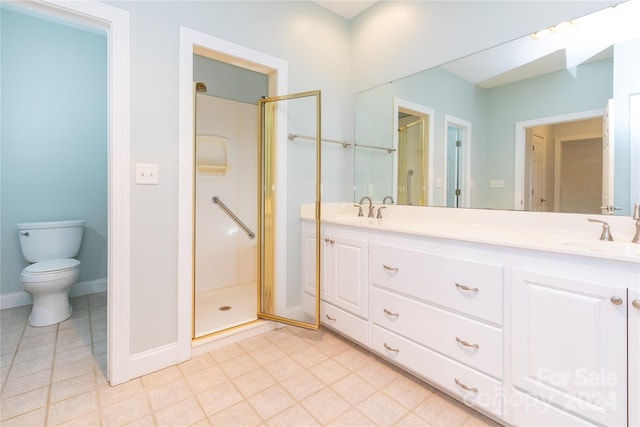 bathroom with vanity, toilet, and an enclosed shower