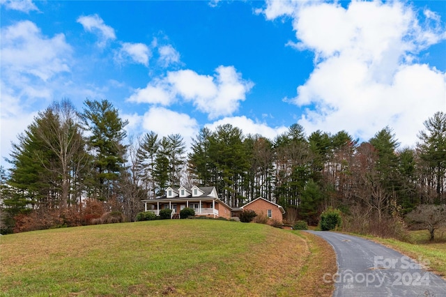 view of front of house featuring a front yard and a porch