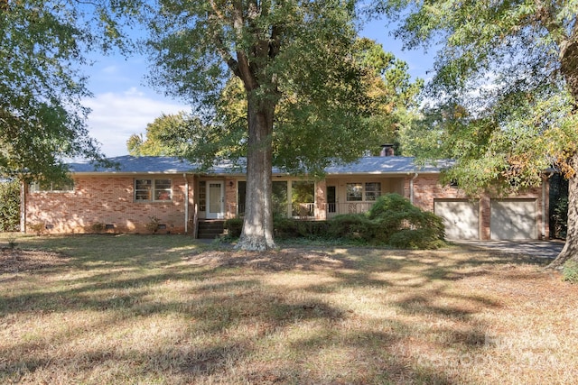 view of front facade with a front yard and a garage