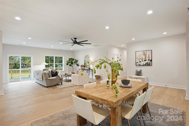 dining space with light hardwood / wood-style flooring and ceiling fan