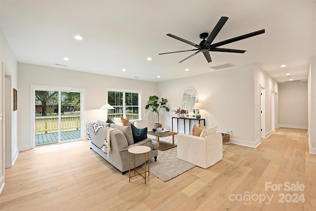 living room featuring light wood-type flooring and ceiling fan