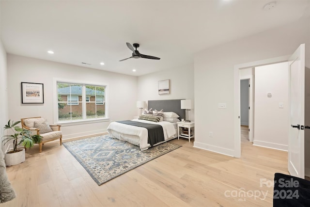 bedroom with ceiling fan and light hardwood / wood-style floors