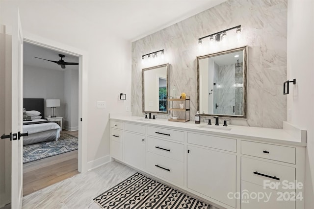 bathroom with vanity, a shower with shower door, hardwood / wood-style flooring, and ceiling fan