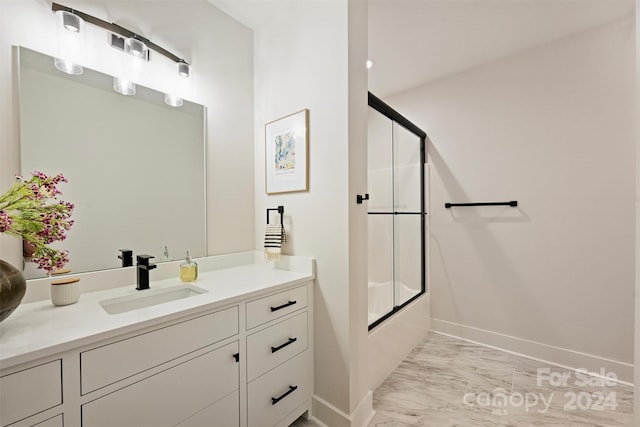 bathroom with vanity and bath / shower combo with glass door