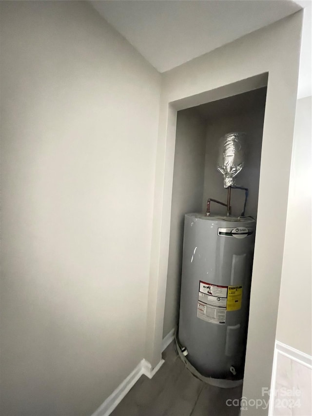 utility room featuring electric water heater