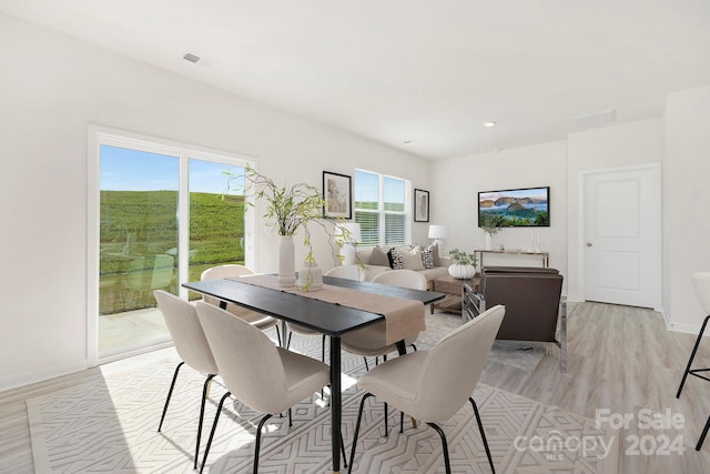 dining space with light hardwood / wood-style floors