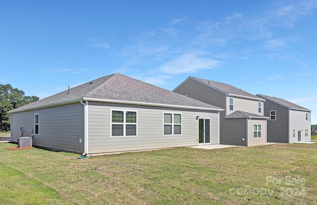 back of house with a patio and a yard