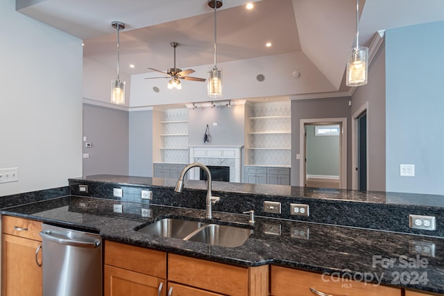 kitchen featuring sink, ceiling fan, dark stone counters, stainless steel dishwasher, and pendant lighting