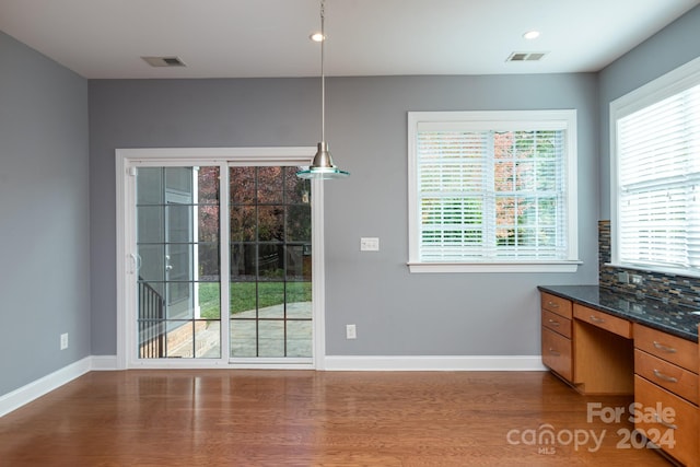 unfurnished dining area featuring hardwood / wood-style flooring