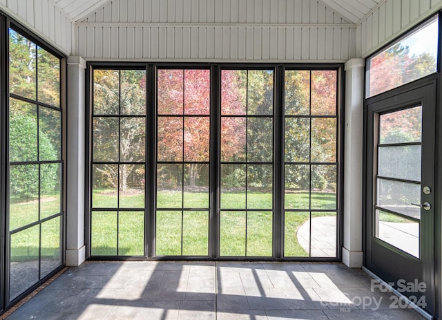 unfurnished sunroom featuring wooden ceiling and vaulted ceiling