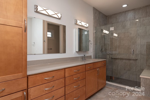 bathroom featuring vanity, tile patterned floors, and a shower with door