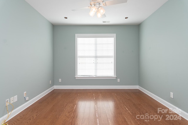 spare room with hardwood / wood-style flooring and ceiling fan