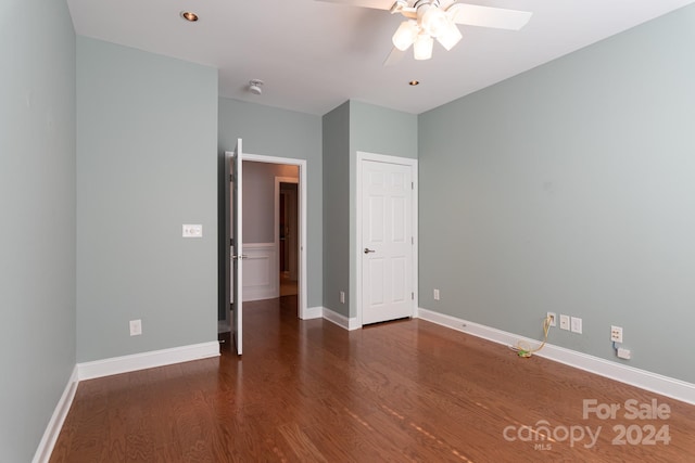 unfurnished bedroom with dark hardwood / wood-style flooring and ceiling fan