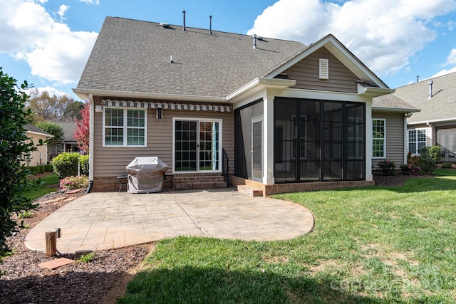 rear view of house with a patio area, a yard, and a sunroom