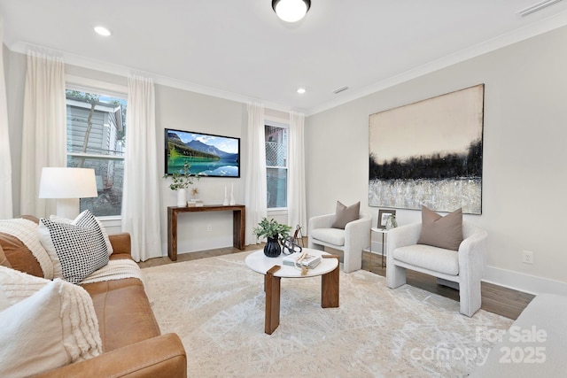 living room with ornamental molding and light hardwood / wood-style floors