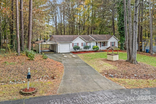 ranch-style home featuring a garage, a porch, a front lawn, and a carport