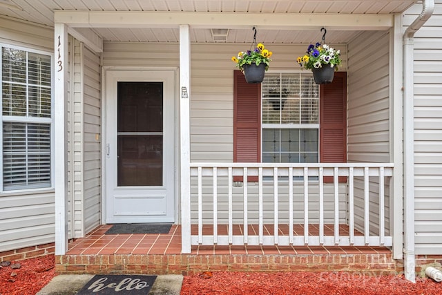 view of exterior entry with a porch