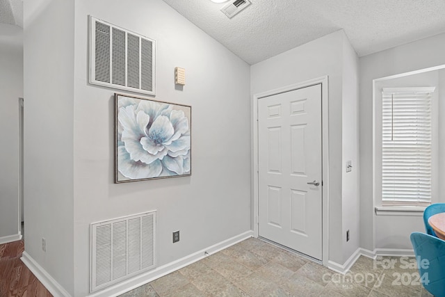 foyer with a textured ceiling