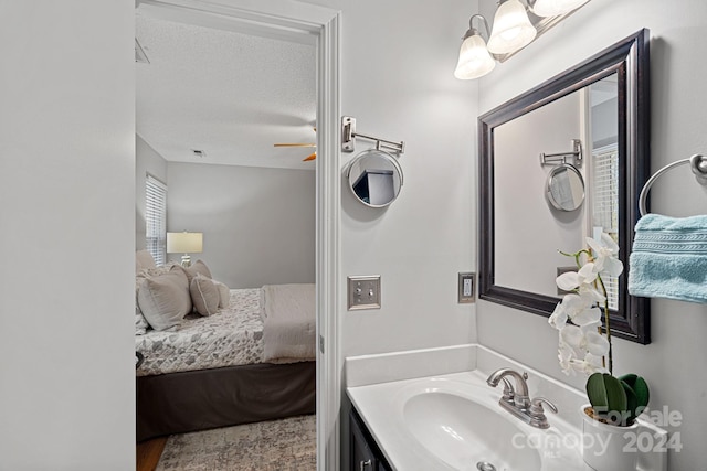 bathroom with vanity, a textured ceiling, and ceiling fan