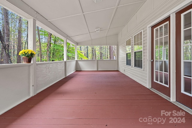 unfurnished sunroom with lofted ceiling