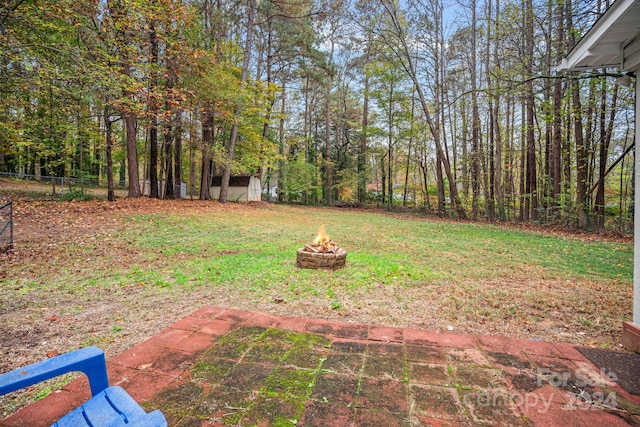 view of yard with an outdoor fire pit