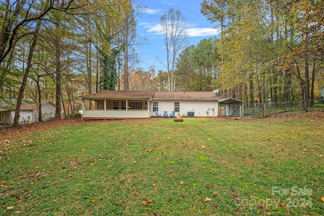 rear view of property with a yard