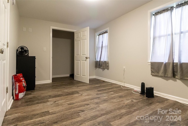 unfurnished bedroom featuring dark hardwood / wood-style flooring