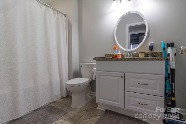 bathroom featuring tile patterned flooring, vanity, and toilet