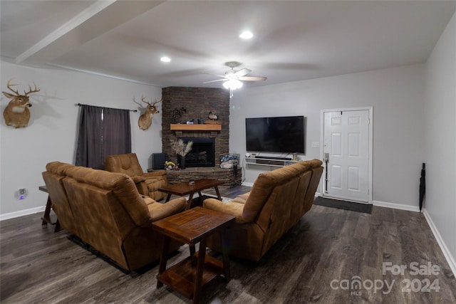 living room with dark wood-type flooring, ceiling fan, and a fireplace