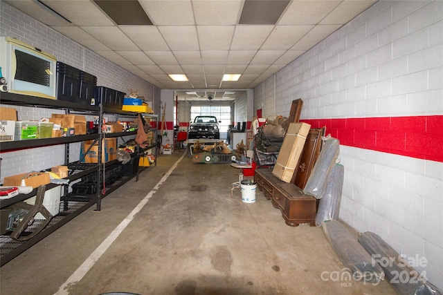 basement with a paneled ceiling