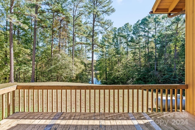 wooden deck featuring a yard