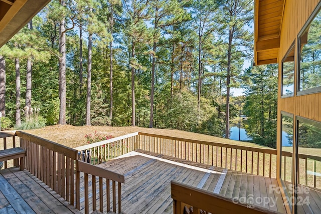 wooden deck featuring a water view